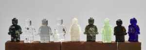 Hannah Gibson Recycling Narratives, Ten Green Bottles Cast glass from recycled glass bottles, 2022.  9 x 5.5 x 2 cm (nine figures); 4 x 3 x 1 cm (one figure)