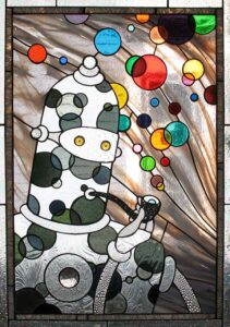 a stained glass window with a polka dot robot