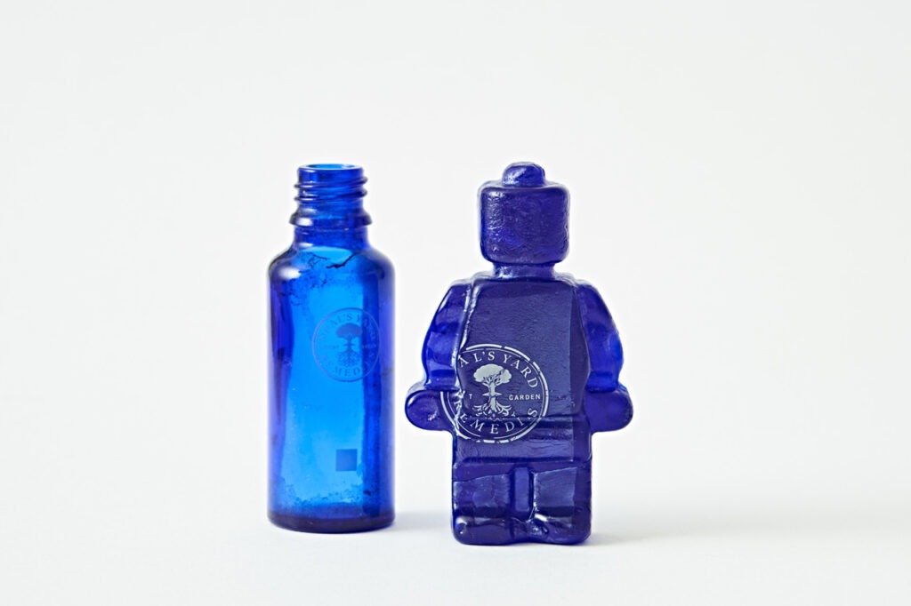 a blue glass figurine and a bottle of liquor