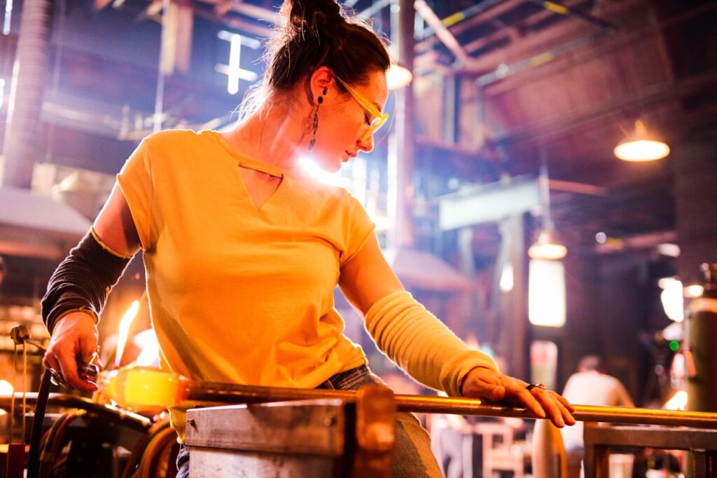 Minhi England working in the hot shop wearing a yellow shirt