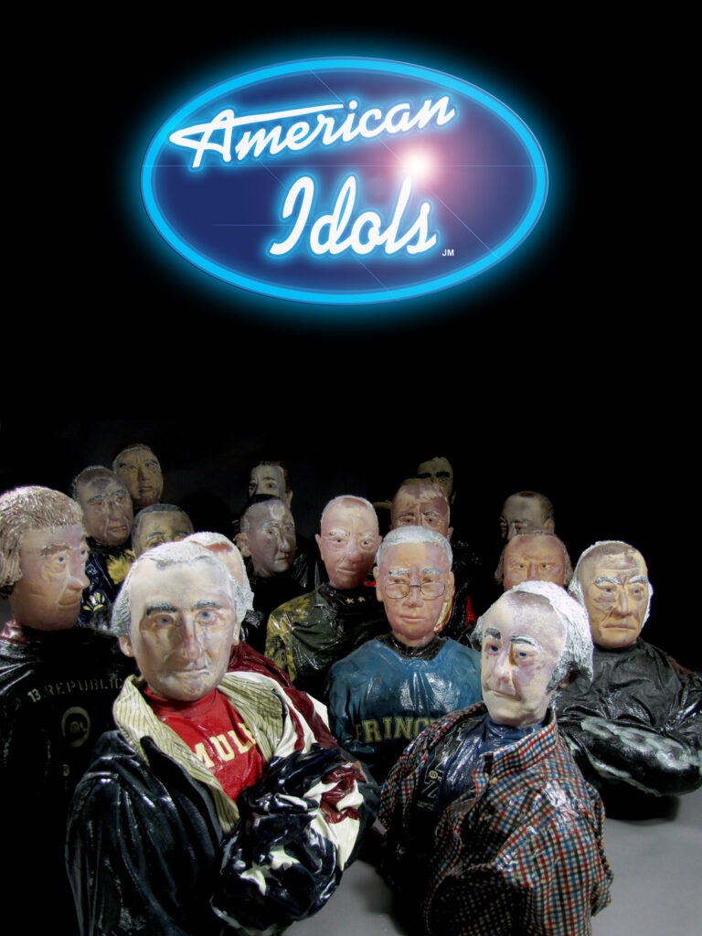 The image shows a neon blue and white sign with the text "American Idols" against a dark background, positioned above a collection of various sculpted glass figures